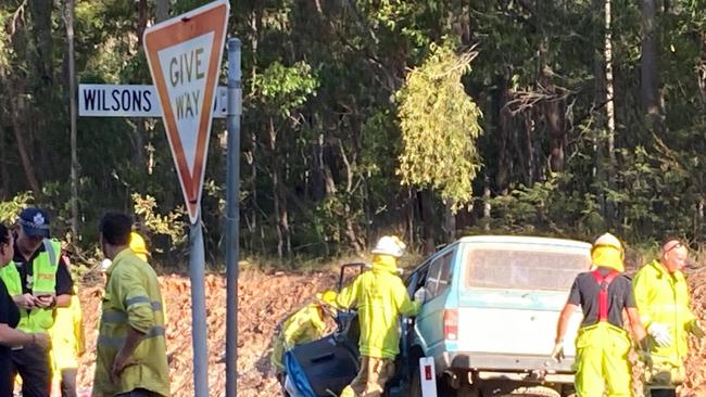 Terrible scenes as emergency workers try to free and work on the two men believed trapped in a ute which was involved in a crash with a full school bus near Gympie on Tuesday afternoon.