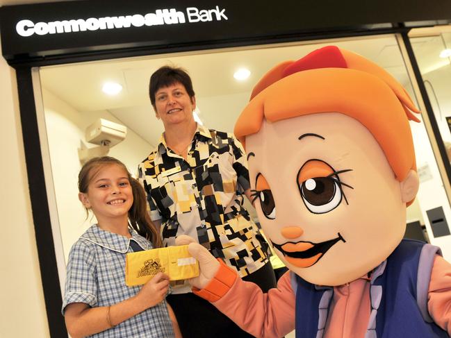 Meghan Cassidy, 8, of St John the Baptist primary school, gets some banking encouragement from the Commonwealth Bank's Jane Cassidy, and Dollarmite Club character Pru, at Deepwater Plaza, Woy Woy.