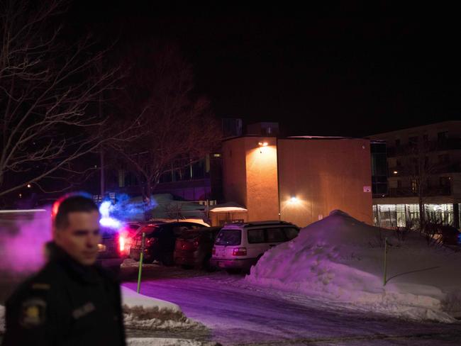 A Canadian police officer outside the Québec City Islamic cultural centre after six people were shod dead by masked gunmen. Picture: AFP / Alice Chiche