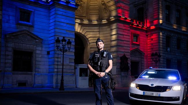 (FILES) French policeman Adrien poses in a night unit uniform (Photo by JULIEN DE ROSA / AFP)