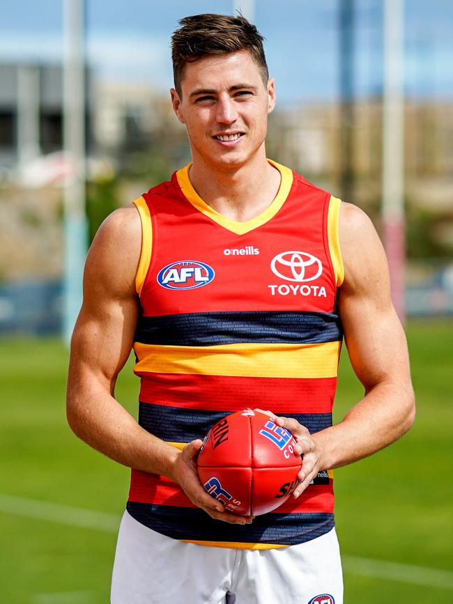 Crows players Shane McAdam and Jake Kelly wearing the new red away jumper