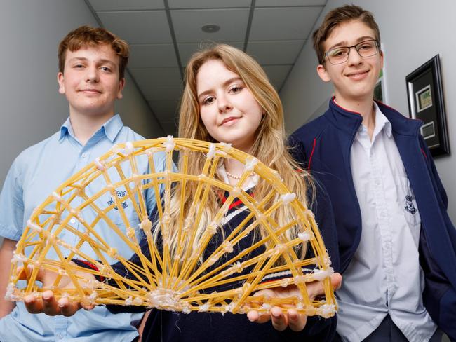 DAILY TELEGRAPH. Transurban bridge building competition for school students, who used pasta to try and build the strongest or best looking bridge design. Pictured are winners of the Transurban prize for creative bridge design, Gosford High year 10 students Flynn Henry, Tamsin Conti and Charlie Manns. 09/08/2024. Picture by Max Mason-Hubers