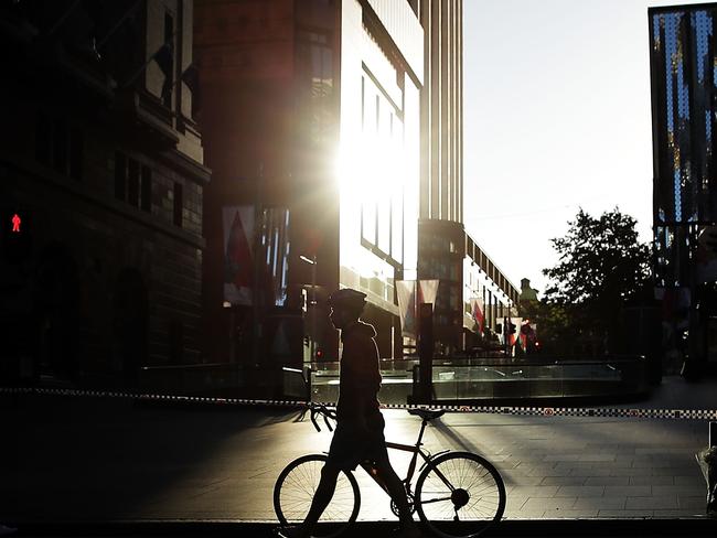 Commuters travel past police tape at Martin Place on their way to work. Picture: Getty Images