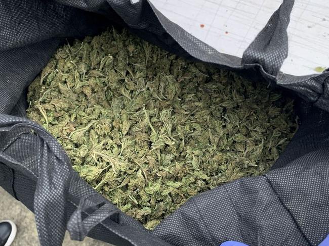 A bag of marijuana is displayed during a police raid as part of Operation Trojan in New Zealand.