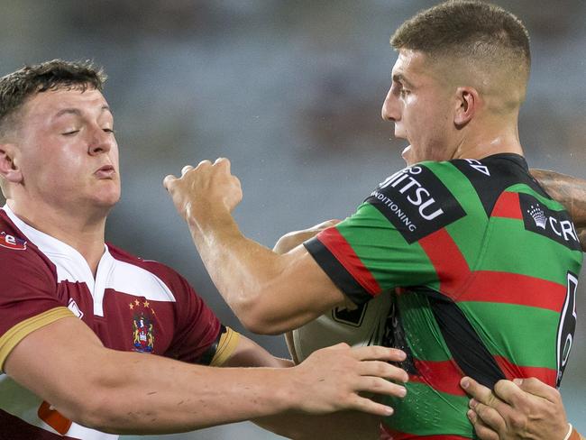 Adam Doueihi of the Rabbitohs is tackled during the NRL International Double Header match between the South Sydney Rabbitohs and the Wigan Warriors at ANZ Stadium in Sydney, Saturday, February 17, 2018. (AAP Image/Craig Golding) NO ARCHIVING, EDITORIAL USE ONLY