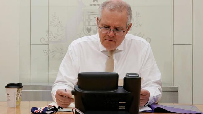 Prime Minister Scott Morrison talks with US President Joe Biden on the phone from Parliament House in Canberra on Friday. Picture: Adam Taylor / PMO