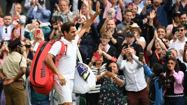 Switzerland's Roger Federer leaves the court after losing to Poland's Hubert Hurkacz during their men's quarter-finals match on the ninth day of the 2021 Wimbledon Championships.