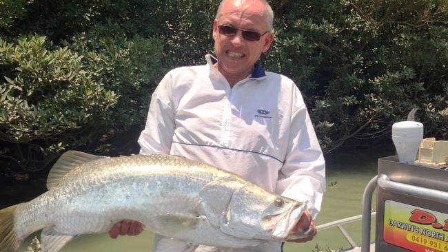 A D.N.A. Barra Fishing client proudly displays a 101cm Darwin Harbour barramundi.