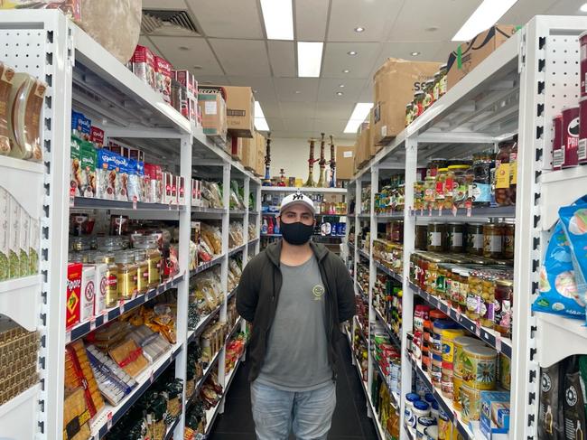 Bahador Zahrouni works at the family New Family Market. Picture: Supplied