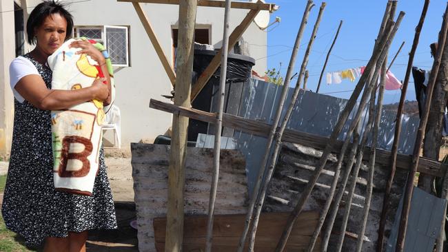 Vandra Simmers with her newborn baby outside her home in Knysna, South Africa.