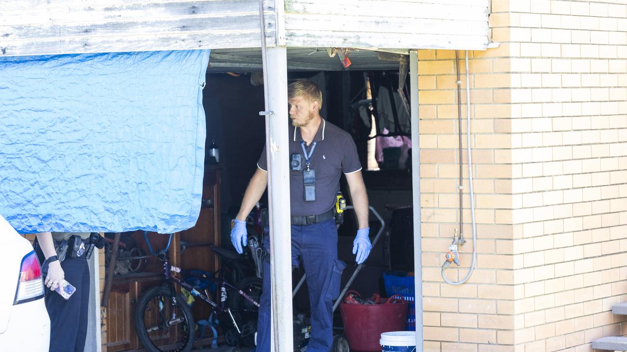 Police search a property across the road from where the woman was found. Picture: Richard Walker