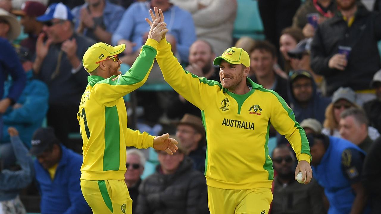 Aaron Finch of Australia celebrates with David Warner after catching Isuru Udana