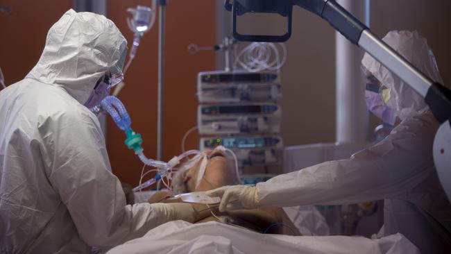 ICU staff at the Casalpalocco COVID-19 Clinic on the outskirts of Rome tend to a patient. Picture: AP