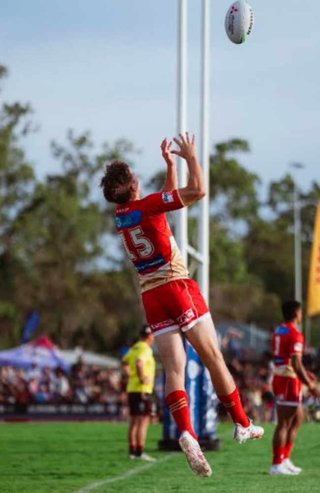 Eli McKay flies high for the Dolphins in their pre-season game against the CQ Capras in Gladstone.