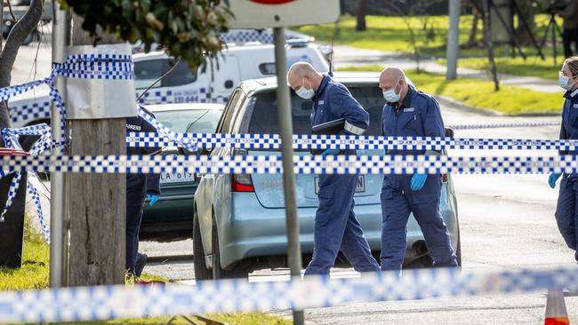 Forensic officrs collect evidence from the scene. Picture: Jake Nowakowski