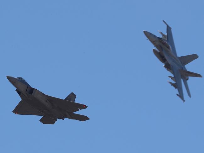 A USAF Raptor (left) with an RAAF F/A-18F Super Hornet over southeast Queensland. Picture: Peter Wallis