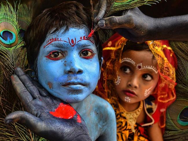 The Make Up ... This little boy was being painted like Lord Krishna as preparation for acting in a village drama, while little Radha was looking on with intense curiosity. Location: India. Picture: Sanghamitra Sarkar (IN)/Siena International Photo Awards 2016