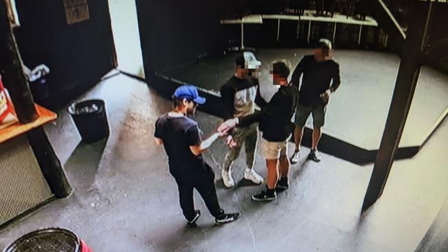 The initial confrontation at Backstage, about 3.05pm, October 15, 2022. Mr Hoyle is in the blue cap, his employee is in the white cap. Picture: Supplied