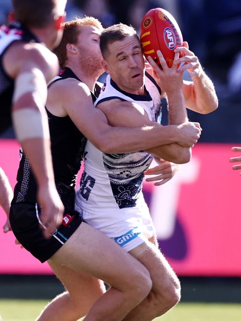 Joel Selwood is taken high by Port Adelaide’s Willem Drew. Picture: Michael Klein