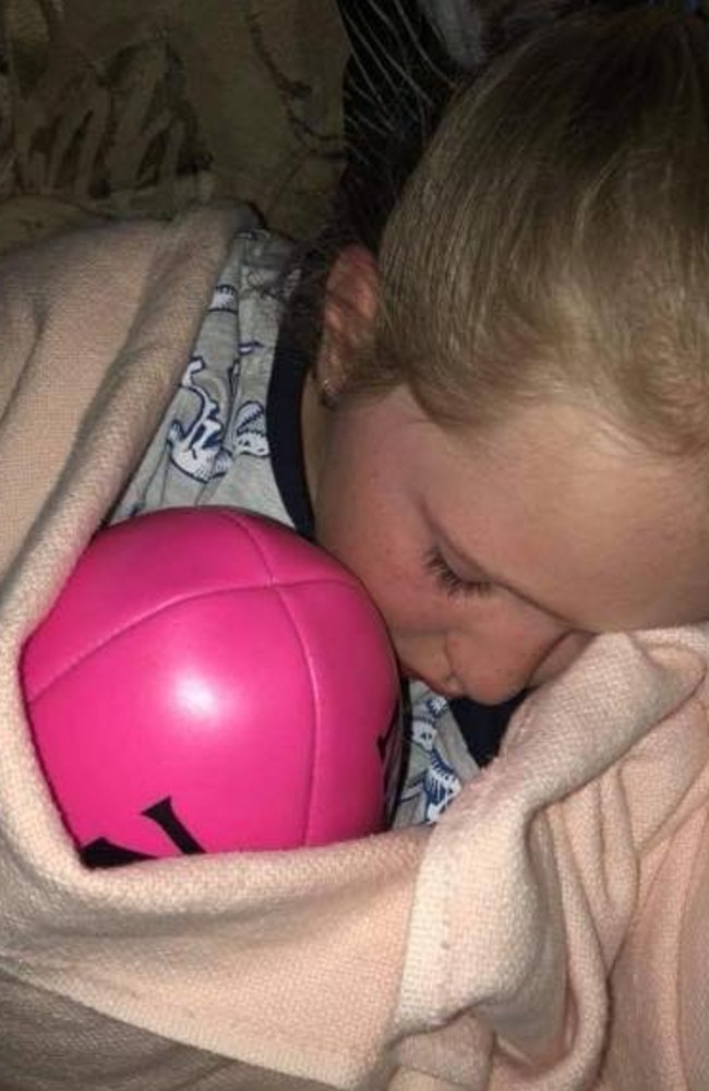 Allie-mae even sleeps with her beloved pink AFL ball.