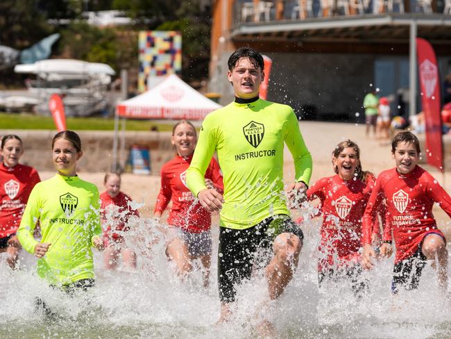 Henry Code (middle) and Lainey Jones (left) teach Sorrento Primary School stduents beach skills as part of the United Energy Portsea Centre of Excellence Program. Picture Henry Yates.