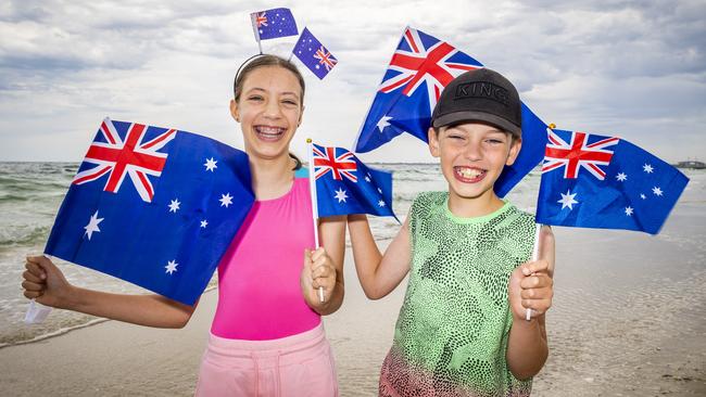 Siblings Ruby, 12 and Jasper, 9 get ready for Australia Day on the beach. Picture: Jake Nowakowski