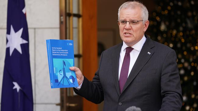 Prime Minister Scott Morrison holding a copy of the Jenkins Review into sexual discrimination inside federal parliament. Picture: Adam Taylor