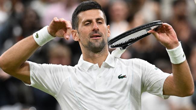 LONDON, ENGLAND - JULY 06: Novak Djokovic of Serbia celebrates winning match point with a violin gesture against Alexei Popyrin of Australia in the Gentlemen's Singles third round match during day six of The Championships Wimbledon 2024 at All England Lawn Tennis and Croquet Club on July 06, 2024 in London, England. (Photo by Mike Hewitt/Getty Images)