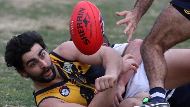 Whittlesea’s Xavier Dimasi fires a handball out off the deck.