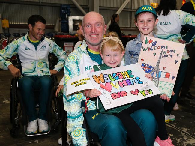 Two-time wheelchair rugby gold medallist, and now assistant national team coach and national development coach, Jason Lees, was welcomed home by his children Dakota and Ashlyn Lee on Wednesday. Picture: NewsWire / Gaye Gerard