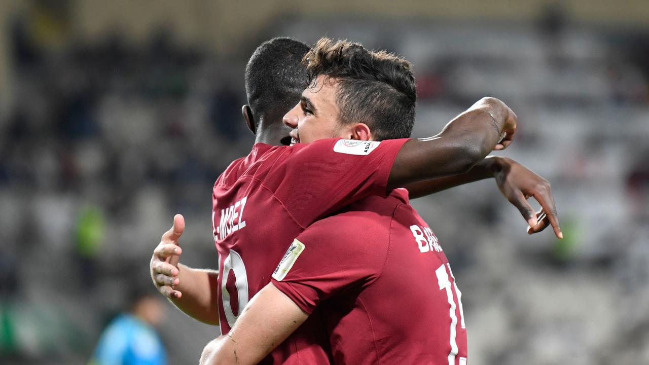 Qatar's defender Bassam Al Rawi (R) celebrates his goal with Qatar's forward Almoez Ali