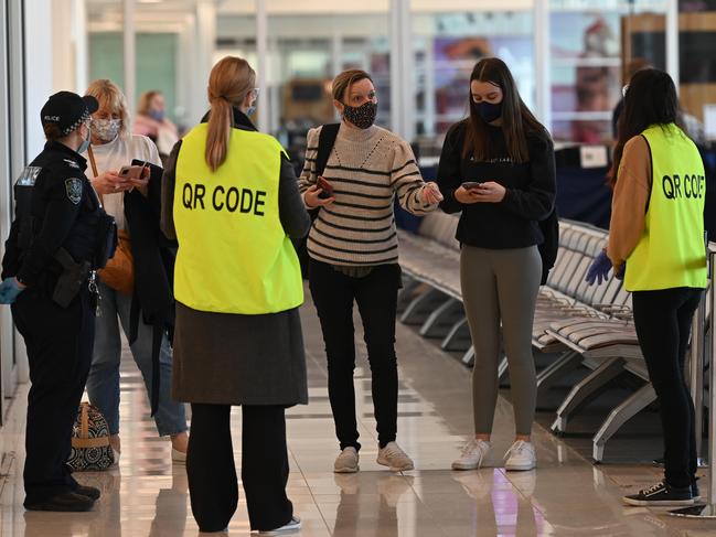 ADELAIDE, AUSTRALIA - NewsWire Photos JUNE 28, 2021:  Passengers who arrived on a flight from Brisbane show they have checked in with the QR code at Adelaide Airport as restrictions around Australia are enforced. Picture: NCA NewsWire / Naomi Jellicoe