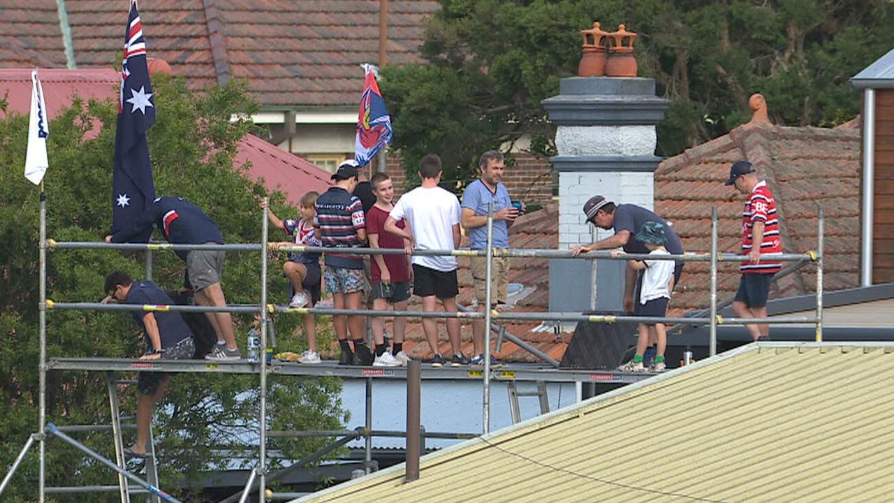 Adam Ferguson erected some scaffolding to watch the footy in his backyard.