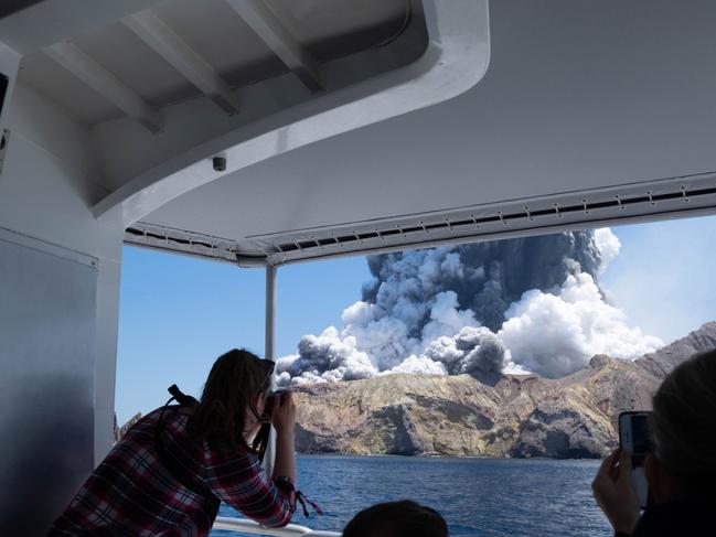 Cruise ship passengers watching the eruption on White Island. Picture: @sch/Michael Schade on Twitter