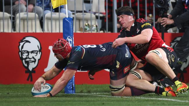 CHRISTCHURCH, NEW ZEALAND - MAY 27: 8. Harry Wilson from the Reds drives over to score in the tackle of Scott Barrett from the Crusaders during the round 15 Super Rugby Pacific match between the Crusaders and the Queensland Reds at Orangetheory Stadium on May 27, 2022 in Christchurch, New Zealand. (Photo by Peter Meecham/Getty Images)