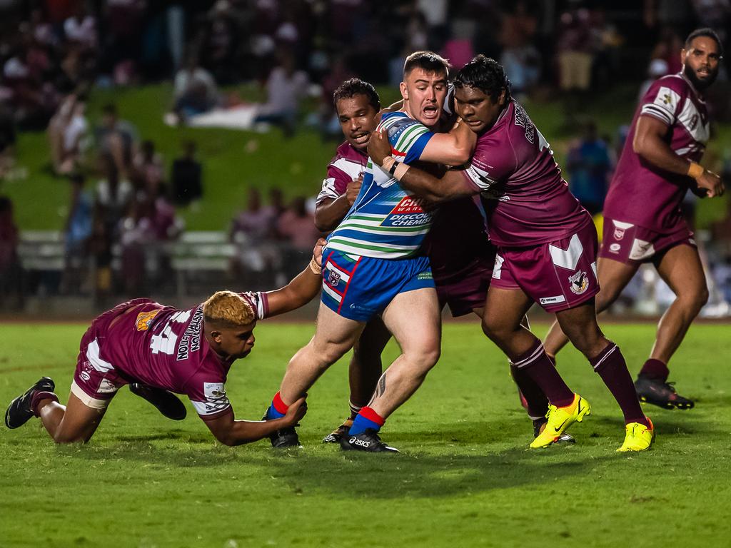 Tamati Huirama is tackled by three Yarrabah Seahawks defenders. Picture: Emily Barker