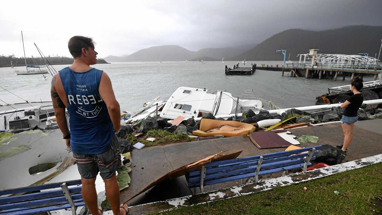 Locals inspect damage at Shute Harbour, Airlie Beach, after Cyclone Debbie's onslaught. Picture: DAN PELED