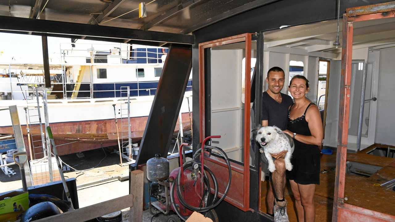 Damien and Jess Ashdown with their dog Mishka onboard Brupeg. Picture: Mike Knott BUN281217BRUPEG6