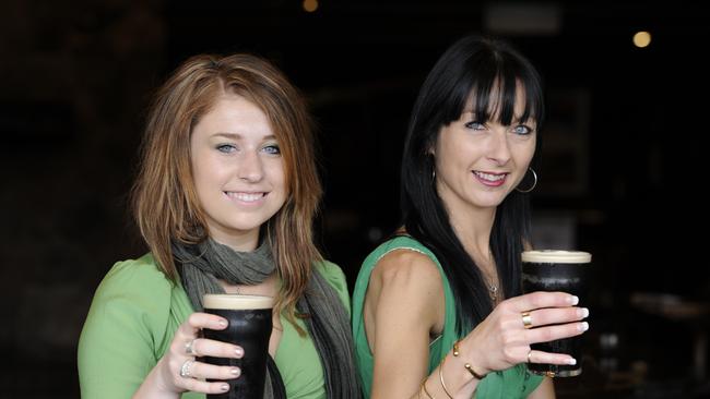 Bar staff Rhiannon Roderick and Jodi Hartje enjoying a glass of Guinness.