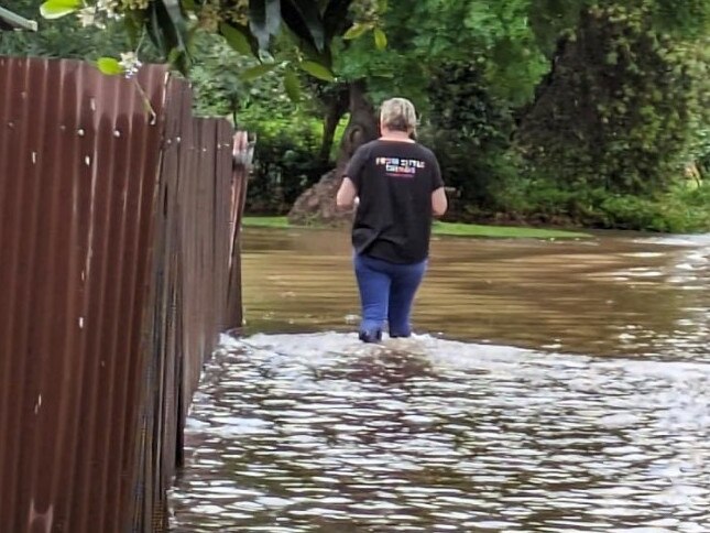 A woman wades through a flooded street in Swan Hill. Picture: Facebook