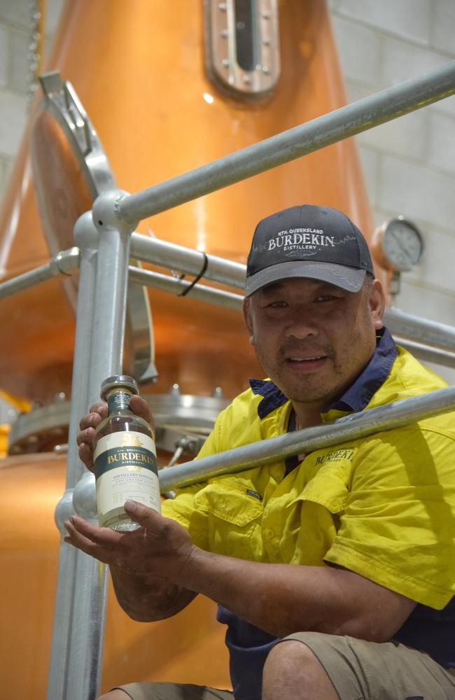 Jason Chan with one of the last unopened bottles from 2023’s JP edition. Behind him is part of Burdekin Rum’s new Italian-made copper distillery plant.