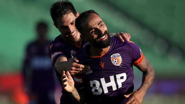 Diego Castro of the Perth Glory celebrates scoring a goal with Bruno Fornaroli, left, during the round-11 A-League match against the Newcastle Jets at HBF Park in Perth on Saturday. Picture: AAP