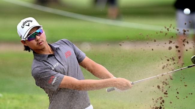 Min Woo Lee plays out of the bunker at the Australian PGA Championship at Royal Queensland. Picture: Bradley Kanaris / Getty Images