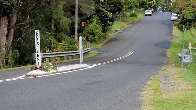 Flowers on Cecil St, Nimbin, where a pedestrian was fatally struck by a vehicle in an alleged hit-and-run incident overnight. Picture: Liana Turner