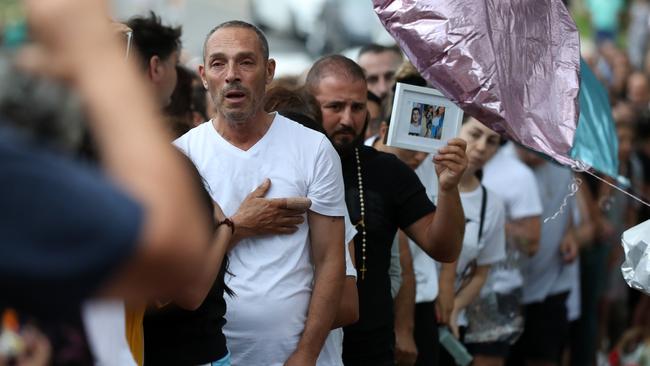 Mourners sang Christian hymns and recited the Lord’s Prayer with the crowd so big it stopped traffic. Picture: Jonathan Ng