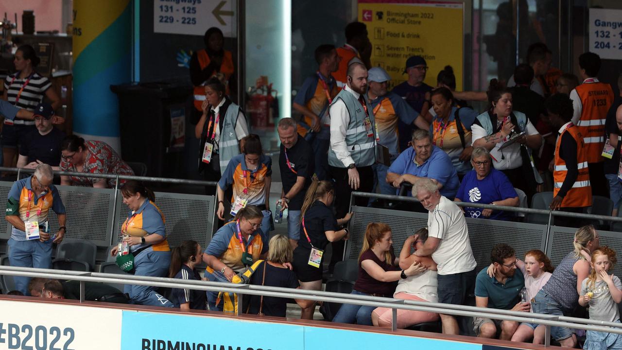 Medics tend to spectators following a massive crash during the men's 15km scratch race