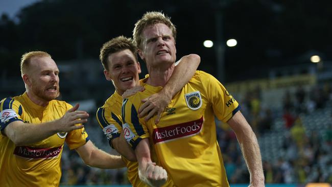 Teammates rejoice with Matt Simon after one of his goals for the Mariners. Picture: Tony Feder/Getty Images