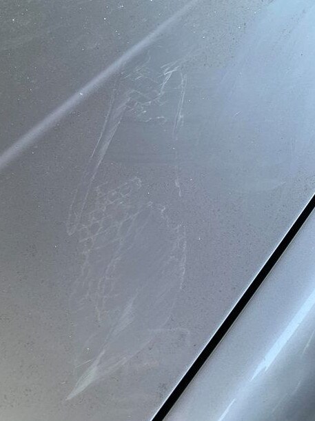 Marks on the worker's smashed car.