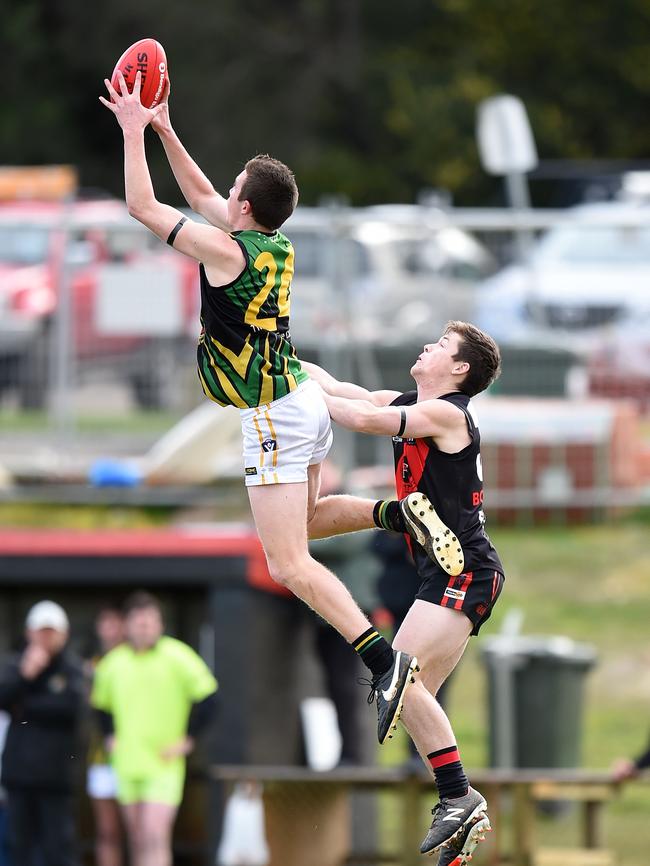 Dromana's Billy Quigley takes a big grab in front of Frankston Bomber Brad Whittley. Picture: Jason Sammon.