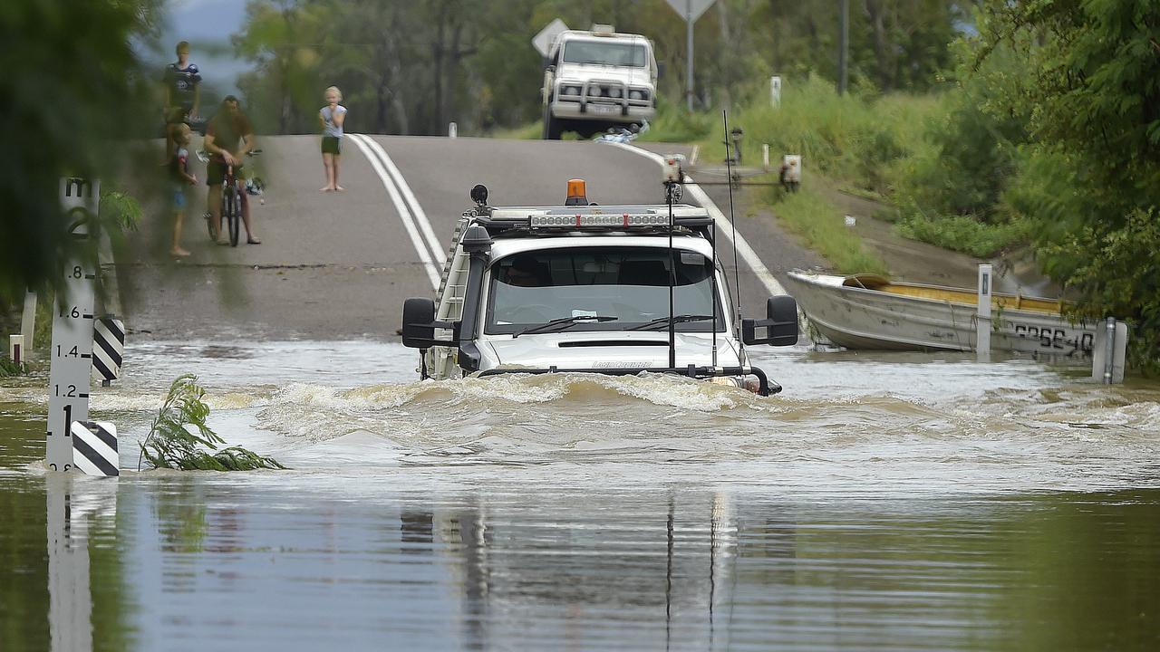 Motorist ignores road closure signs to drive through metre high flood ...